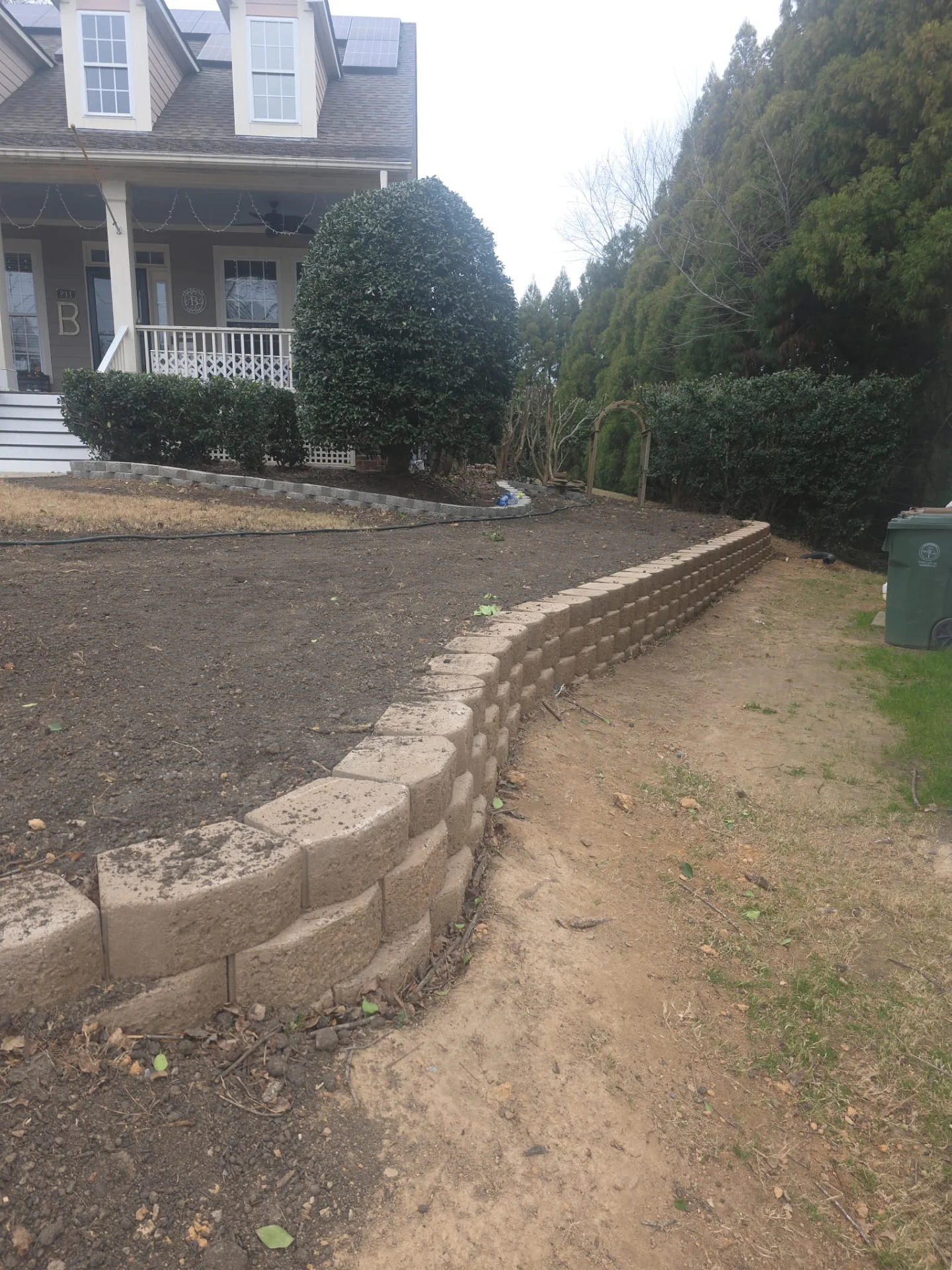 Curved retaining wall with landscaping