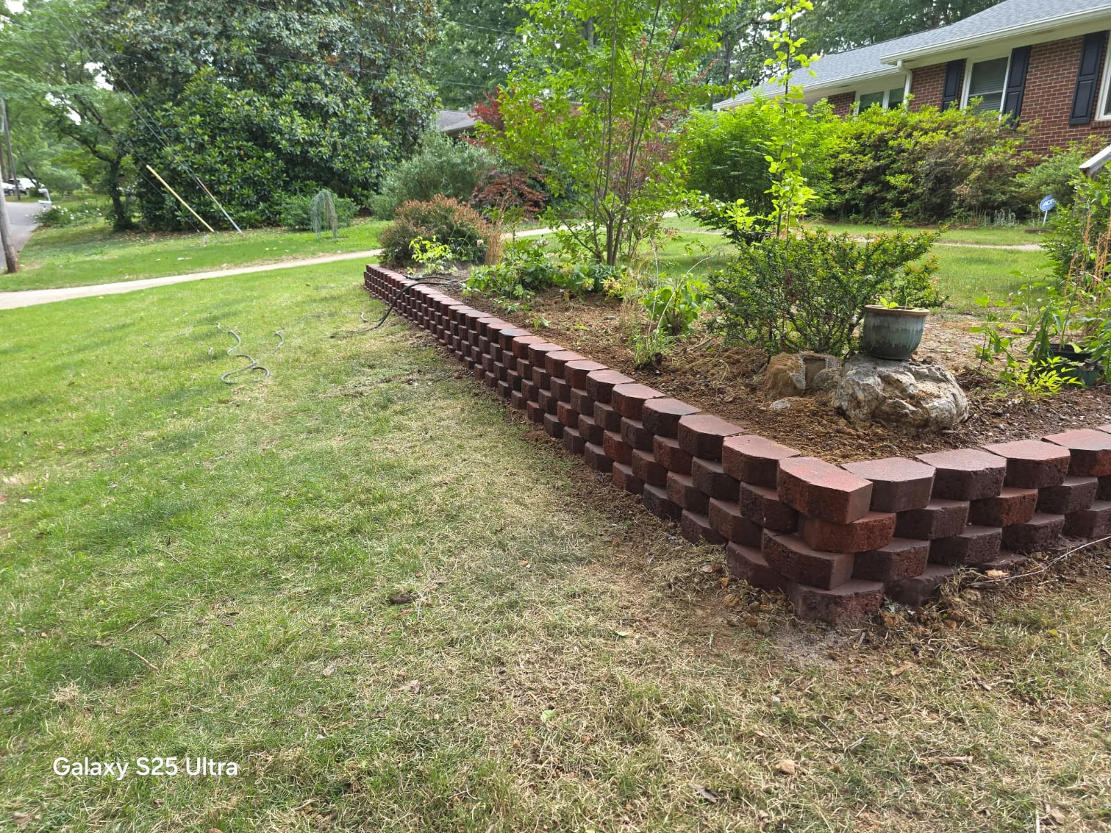 Brick retaining wall installation in progress