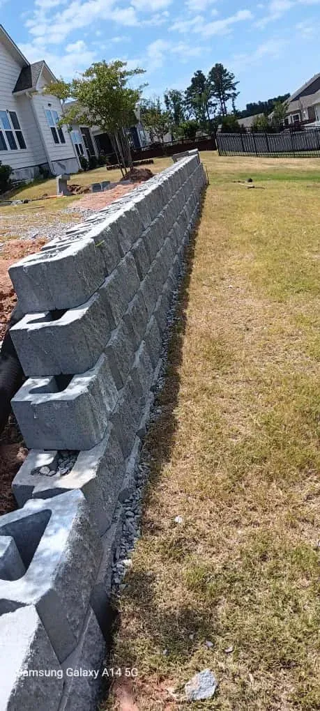 Finished retaining wall with residential landscaping