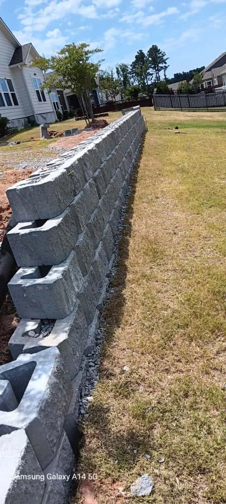 Finished retaining wall with residential landscaping
